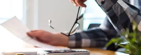 Person Going Through Paperwork From Bankruptcy Attorney